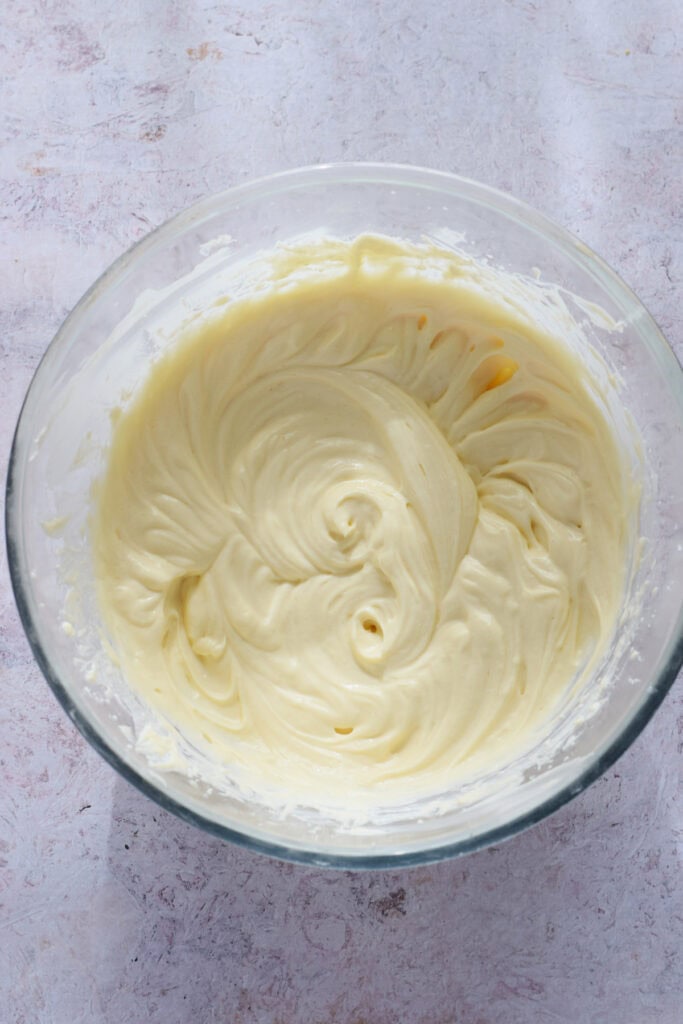 Cheesecake batter in a glass bowl.