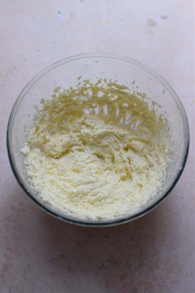 Creamed butter and sugar in a glass bowl.
