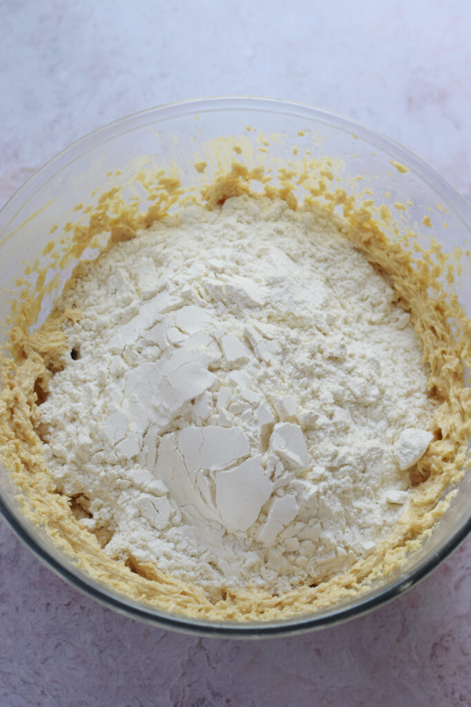 Adding flour to cookie dough.