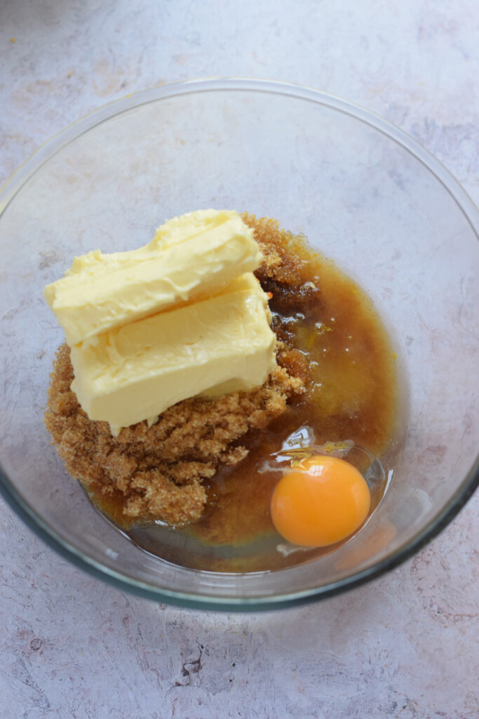 Butter, sugar and egg in a bowl to make cookies.