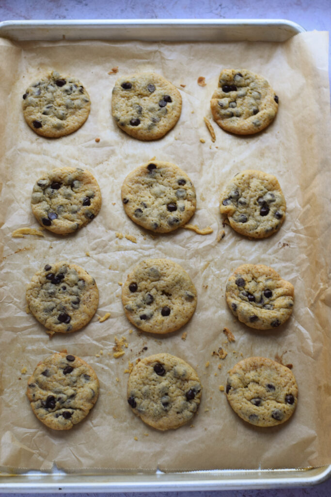 Baked chocolate chip orange cookies on a tray.