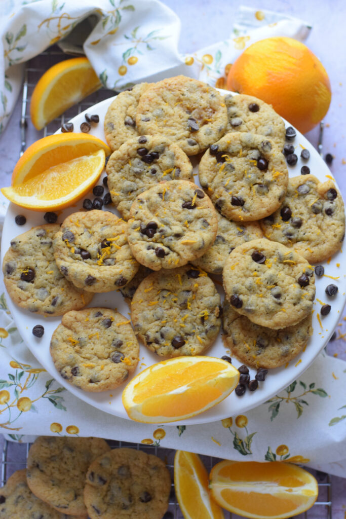 Orange chocolate chip cookies on a plate.