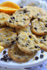 Chocolate chip orange cookies on a white plate.