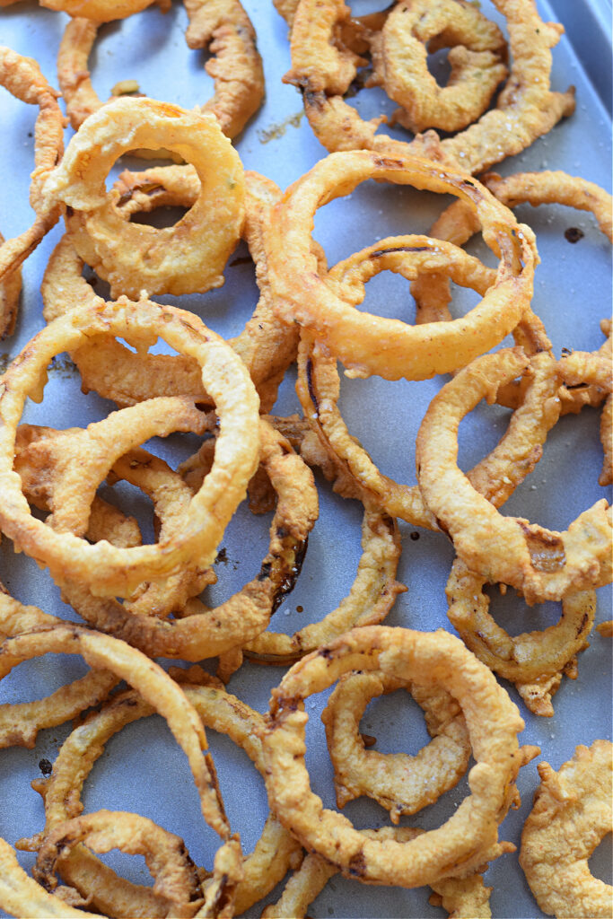 Onion rings on a baking sheet.