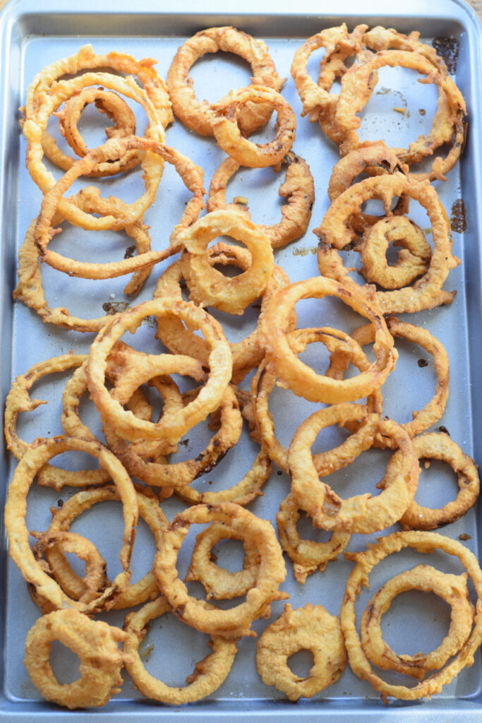 Onion rings on a baking sheet.