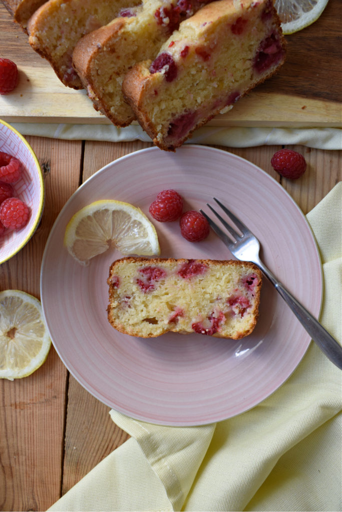 over head view of a slice of raspberry lemon loaf cake