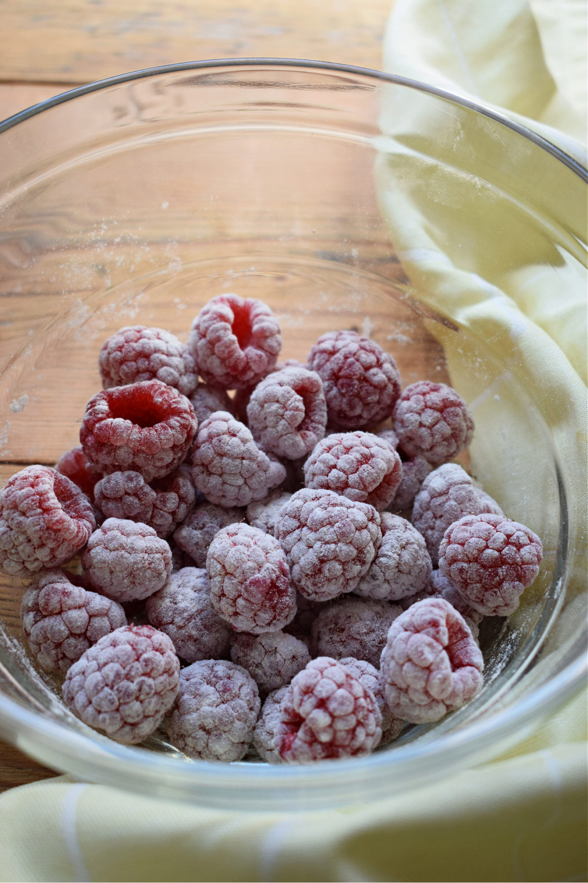 FRESH RASPBERRIES IN A BOWL DUSTED WITH FLOUR