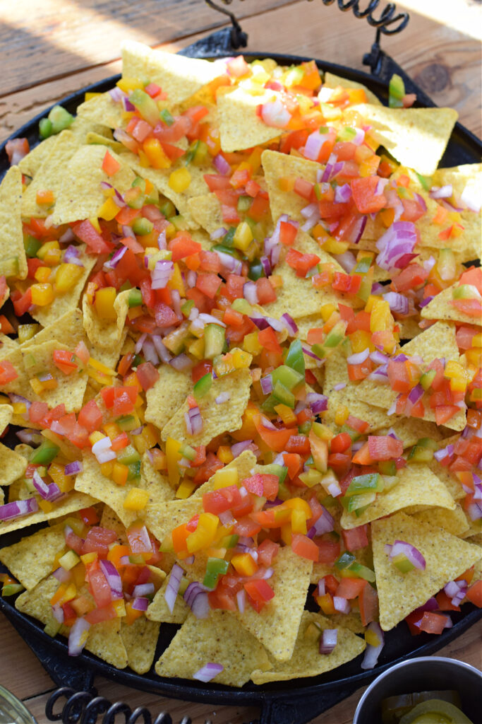 Nachos topped with vegetables.