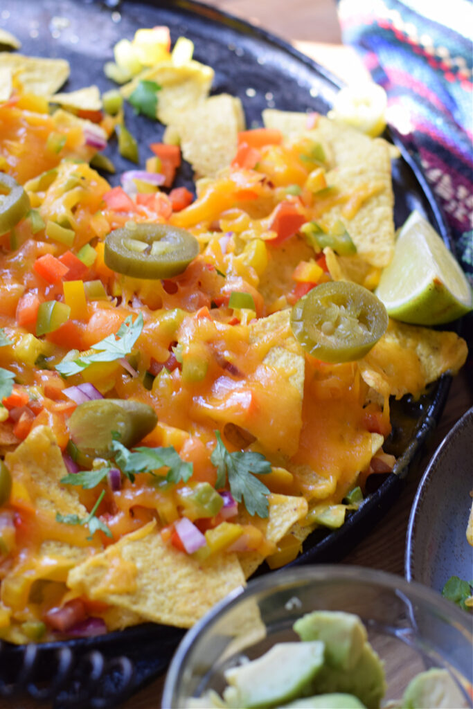 Close up of loaded veggie nachos.