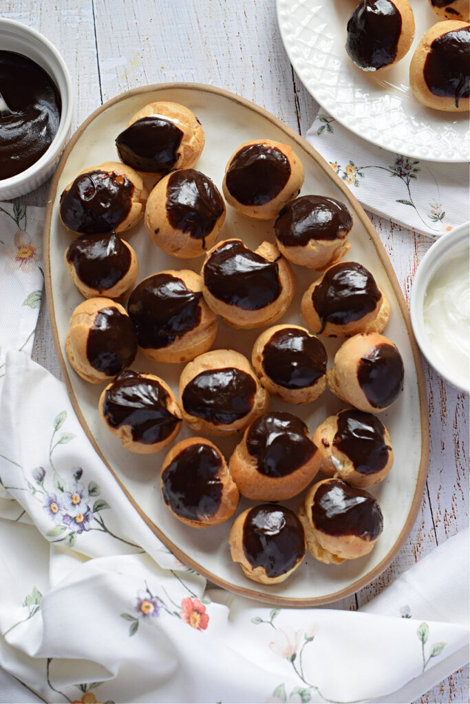 Profiteroles on a white tray.