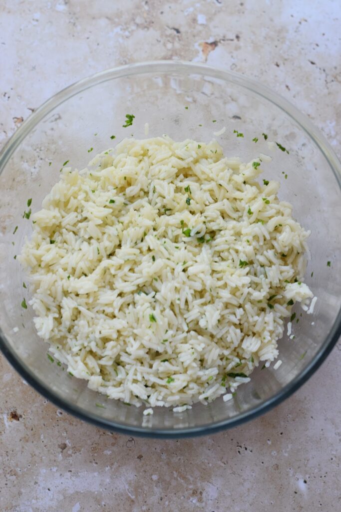 White rice in a bowl with a vinaigrette.
