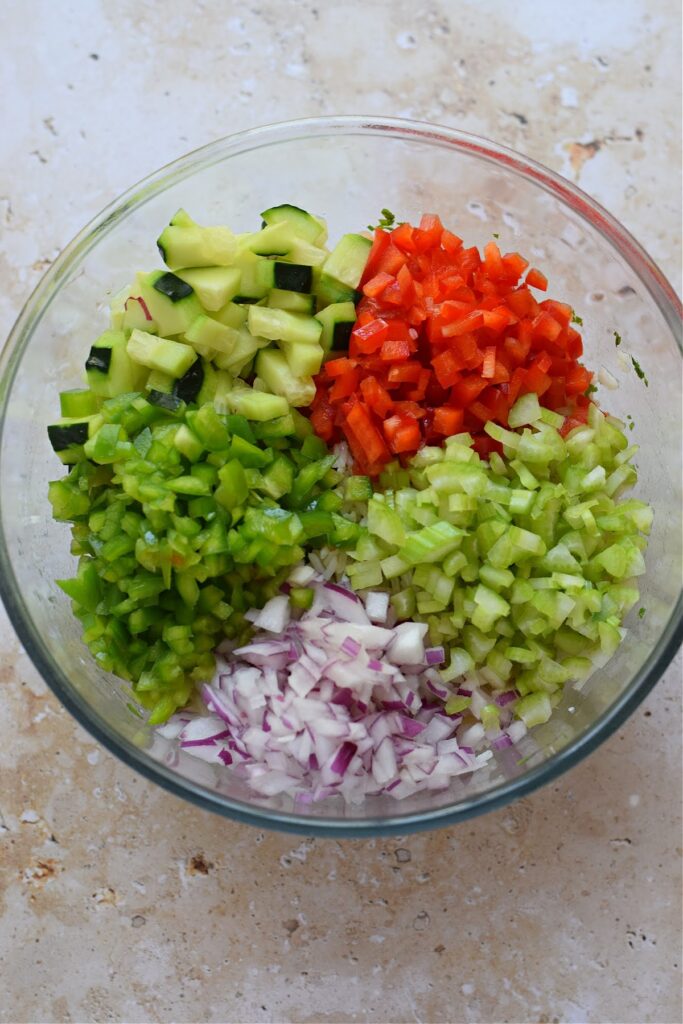 Adding vegetables to a bowl of rice.