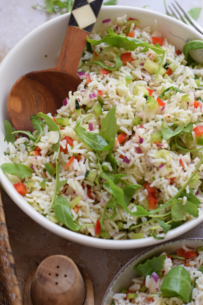 Close up of rice salad in a white bowl.