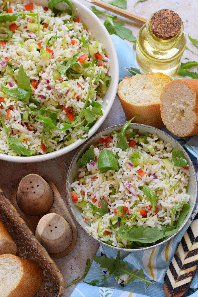 Rice salad with vegetables in bowls.