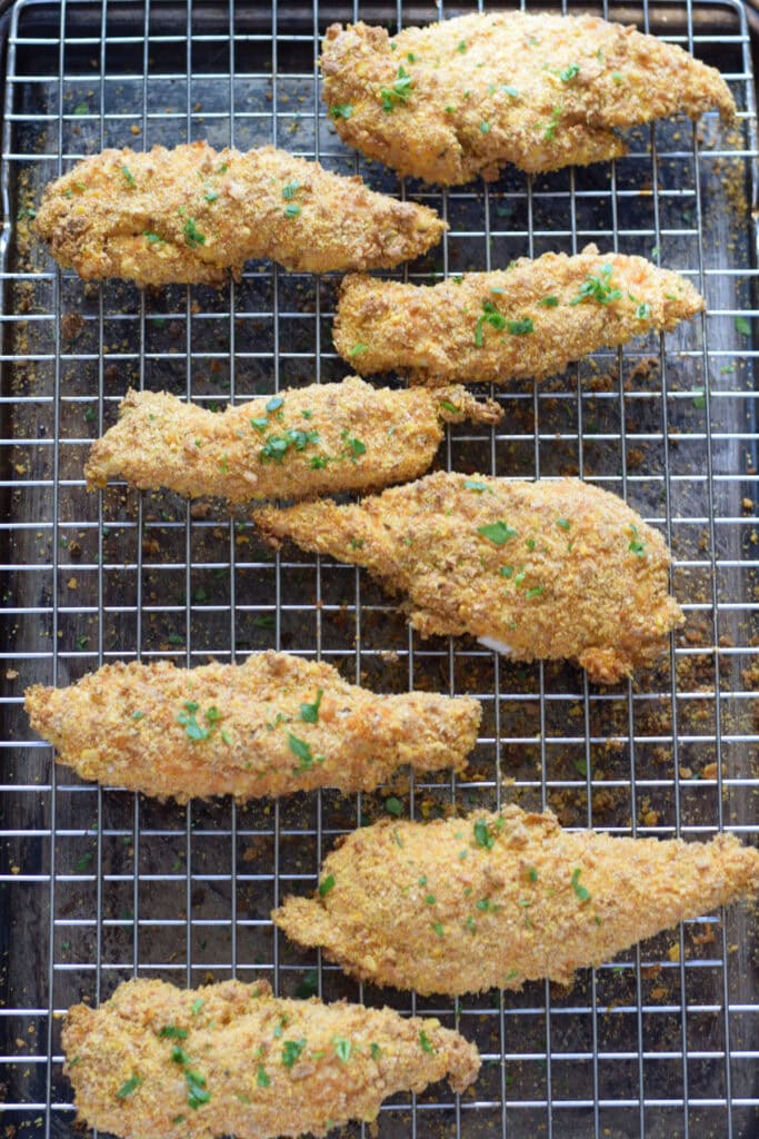 Baked chicken tenders on a tray.