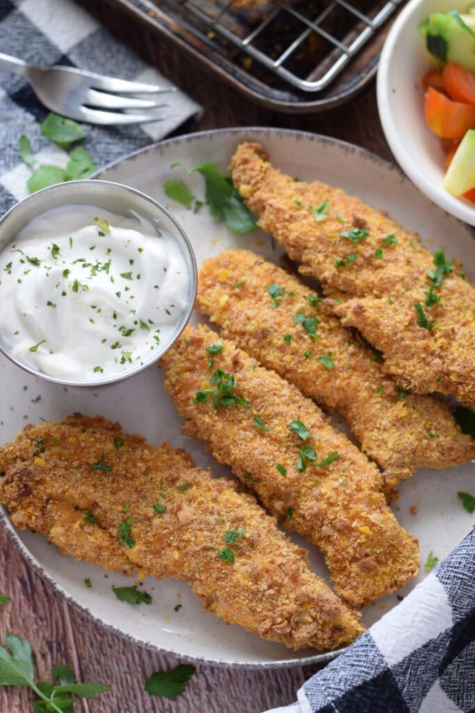 Baked cajun chicken tenders with a dip.