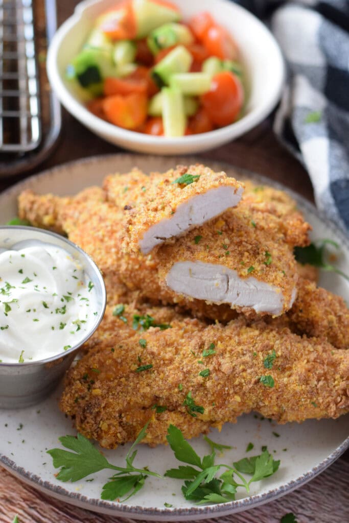 Close up of cajun chicken tenders on a plate.