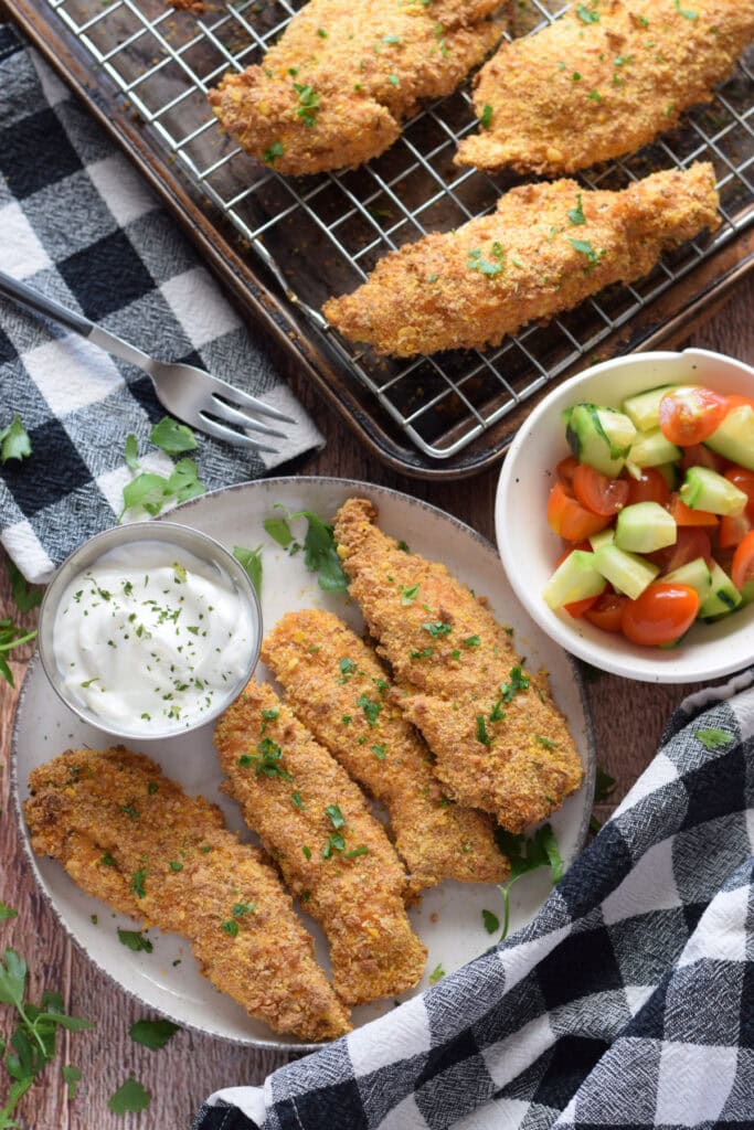 Baked cajun chicken tenders on a plate.
