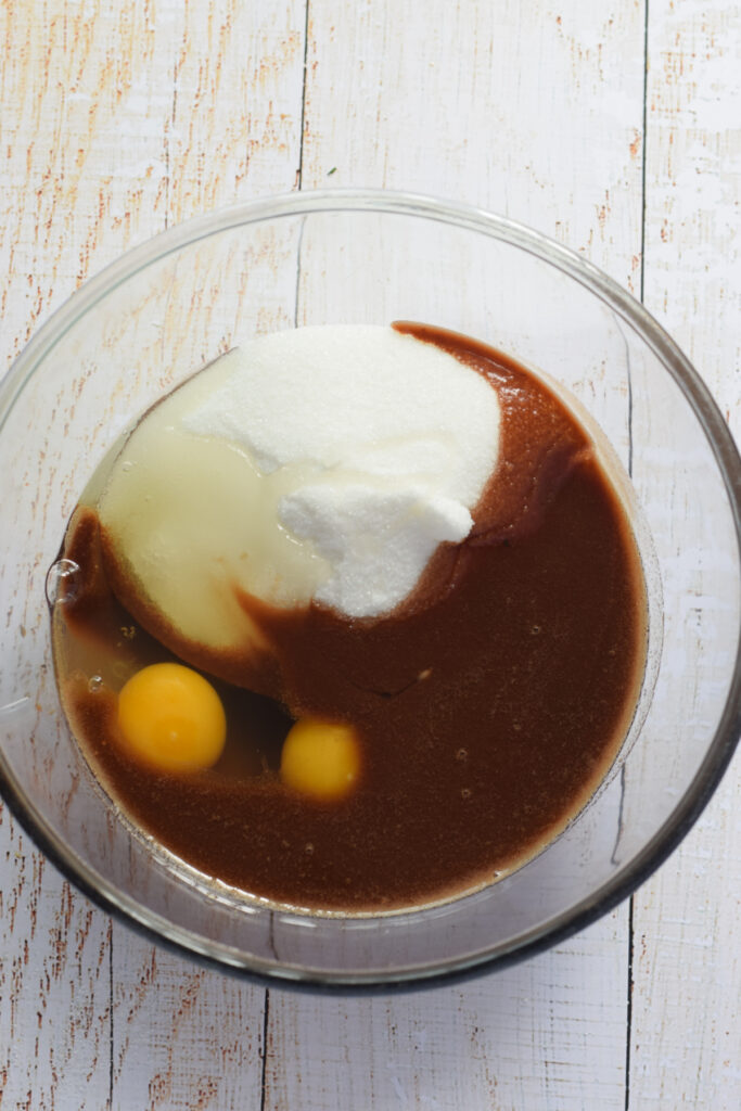 Making chocolate cookie dough in a glass bowl.