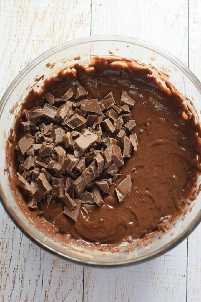 Making chocolate cookie dough in a glass bowl.