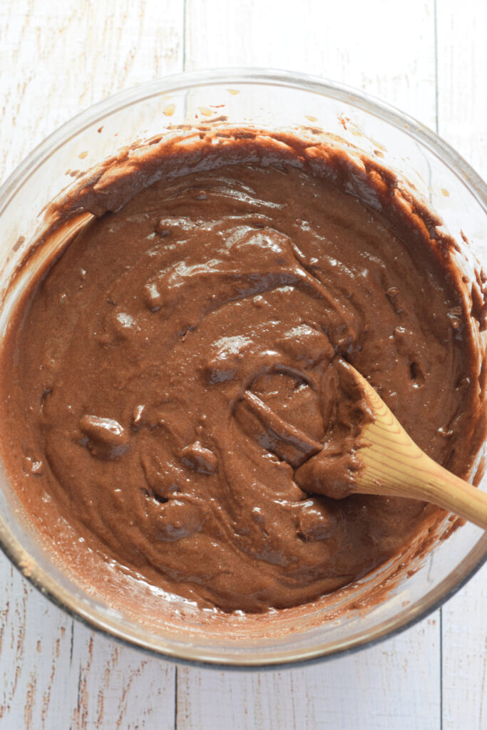 Making chocolate cookie dough in a glass bowl.