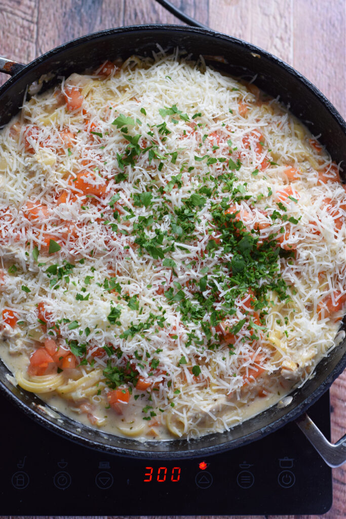 Creamy pasta dish topped with parmesan and parsley.