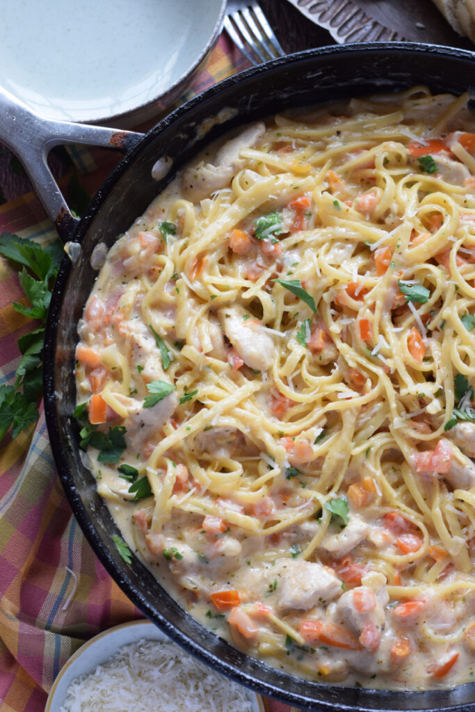 Pasta in a skillet with chicken.