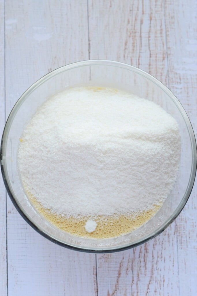 Making a coconut bar filling in a glass bowl.
