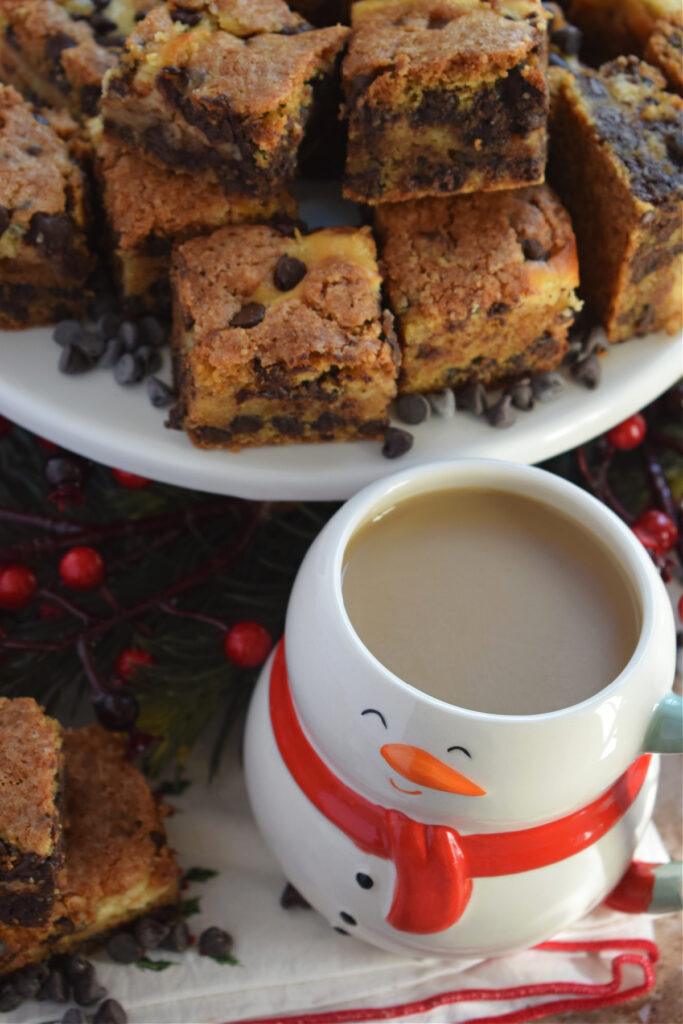 Chocolate chip cookie bars with a snowman mug.