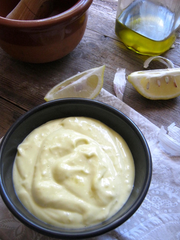 Alioli sauce with lemons, olive oil and a napkin