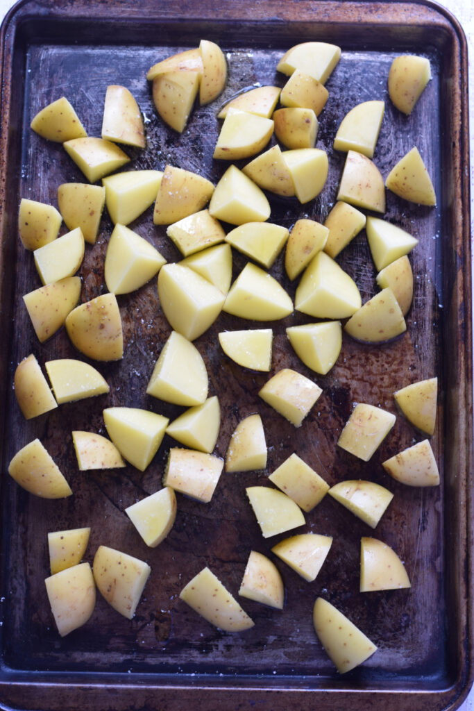 Potatoes on a baking tray.