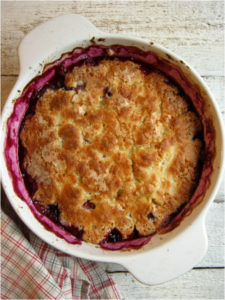 over head view of a baked raspberry blueberry pudding cake