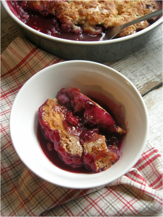 over head view of the Blueberry & Raspberry Baked Pudding Cake in a dessert bowl