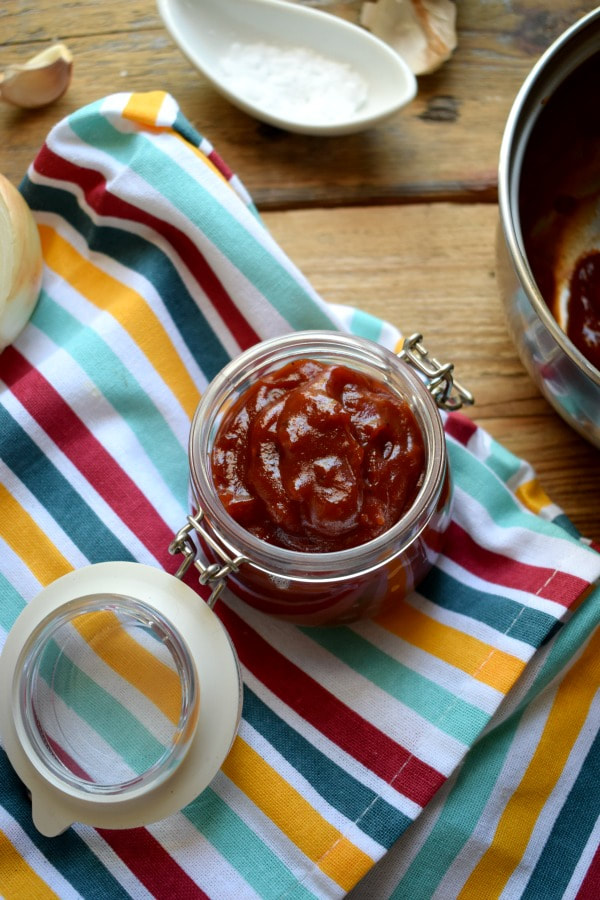 Barbecue sauce in a jar on a tea towel