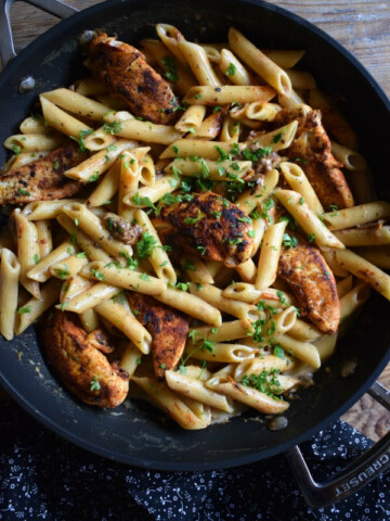 creamy sun dired pasta and chicken in a skillet