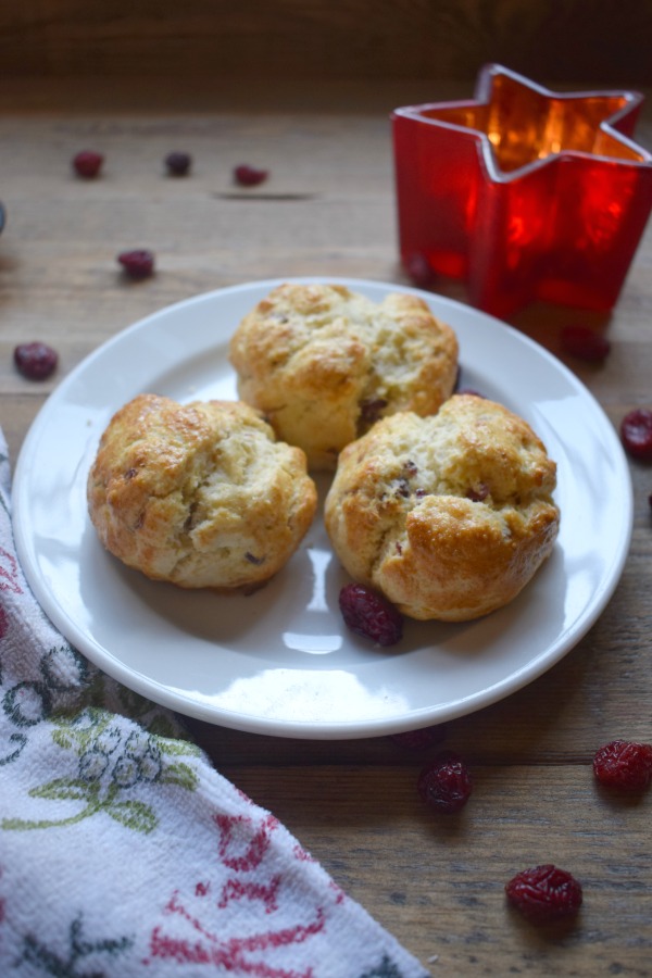 cranberry scones on a plate wiht a tea towel