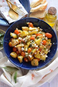 Potato and feta salad in a blue bowl.