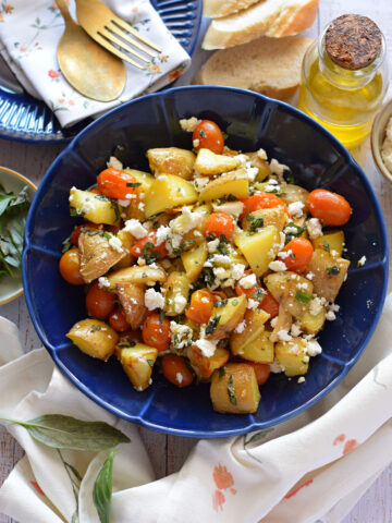 Potato and feta salad in a blue bowl.
