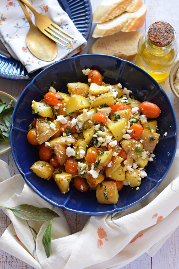 Potato and feta salad in a blue bowl.
