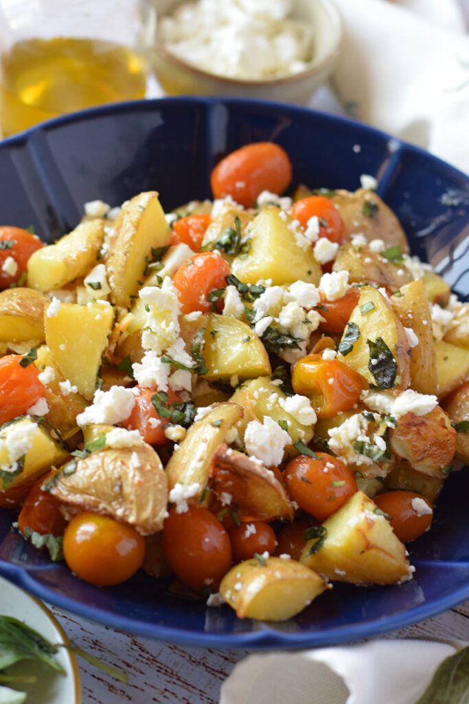 Close up of potato and cherry tomato salad.