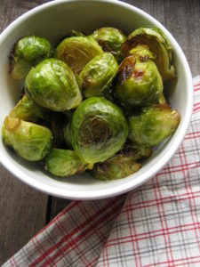 roasted garlic brussel sprouts in a white bowl