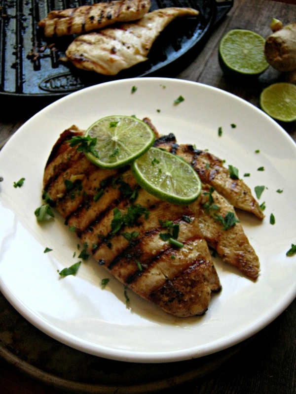 Ginger & Lime Skillet chicken on a white plate with lime slices