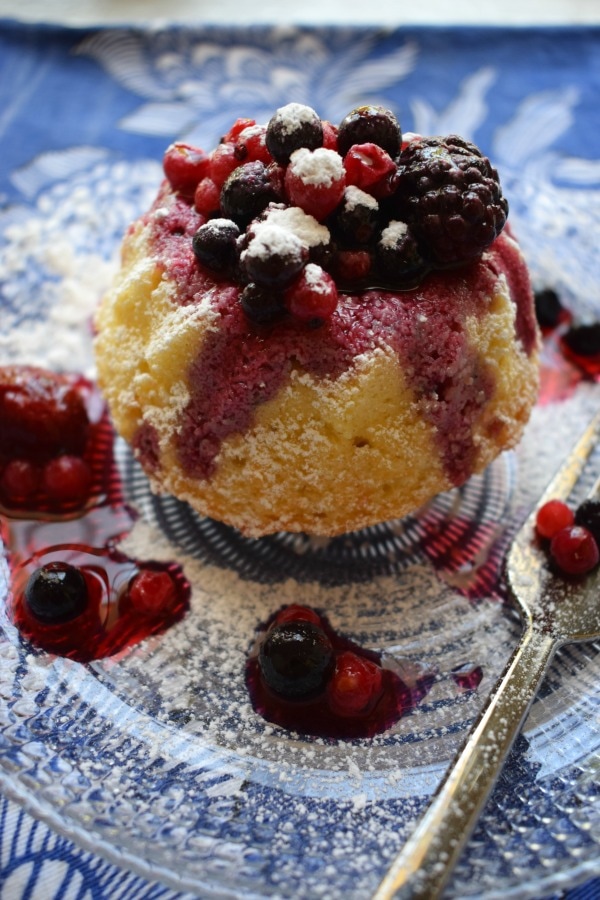 close up of berries with a mini bundt cake