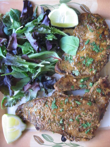 moroccan spiced pan seared tuna steaks on a plate with a salad