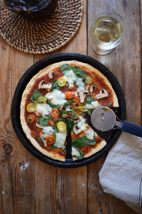 Table setting of a pizza and a glass of wine