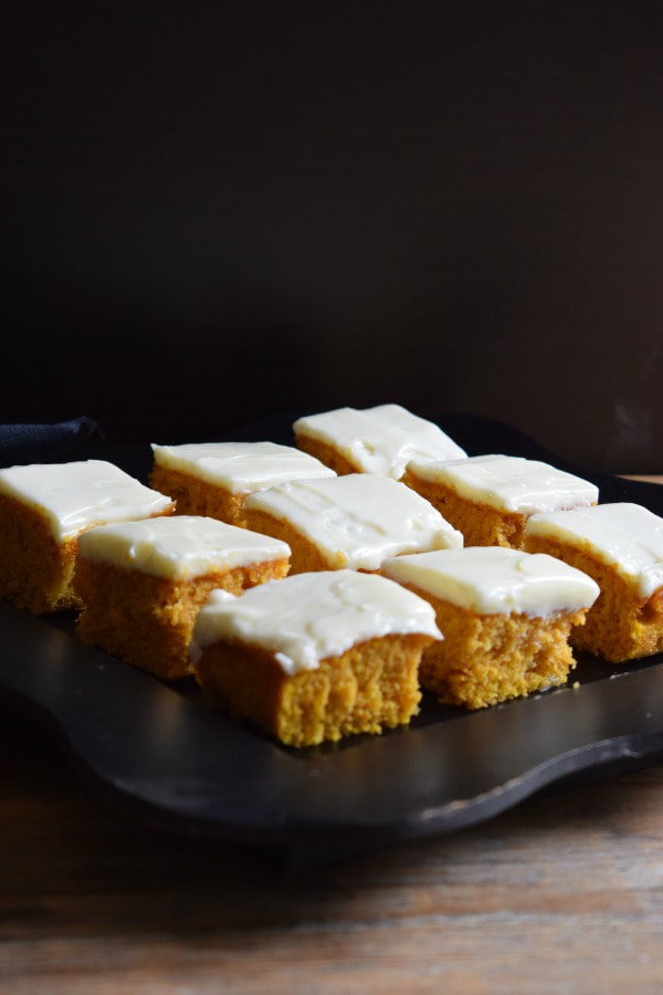 pumpkin spice cake squares with a black background