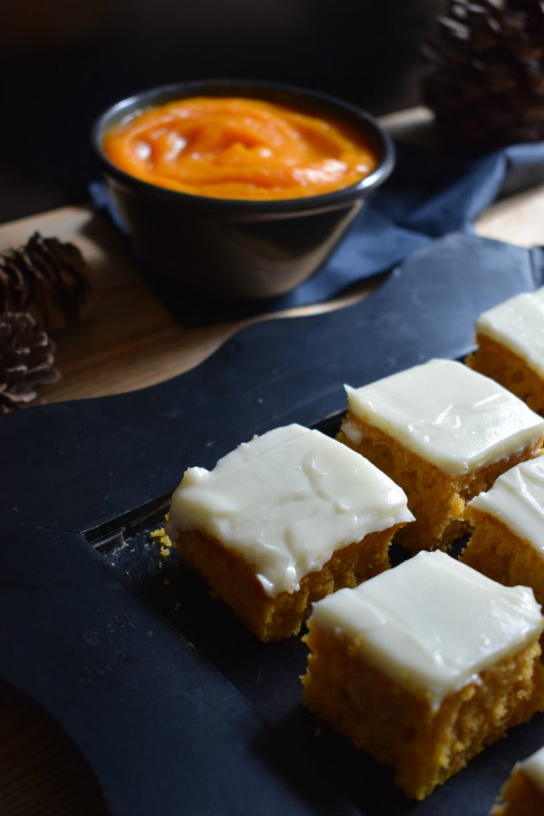 pumpkin spice cake squares on a black serving tray