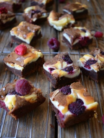 Raspberry Chocolate Cream Cheese Brownies on a wooden board