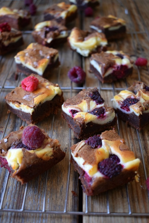Raspberry Chocolate Cream Cheese Brownies on a wooden board