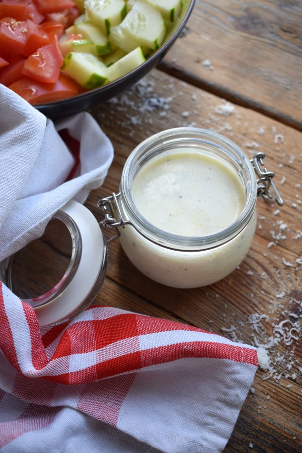 Creamy Greek Yoghurt Dressing on a wooden table with fresh vegetables